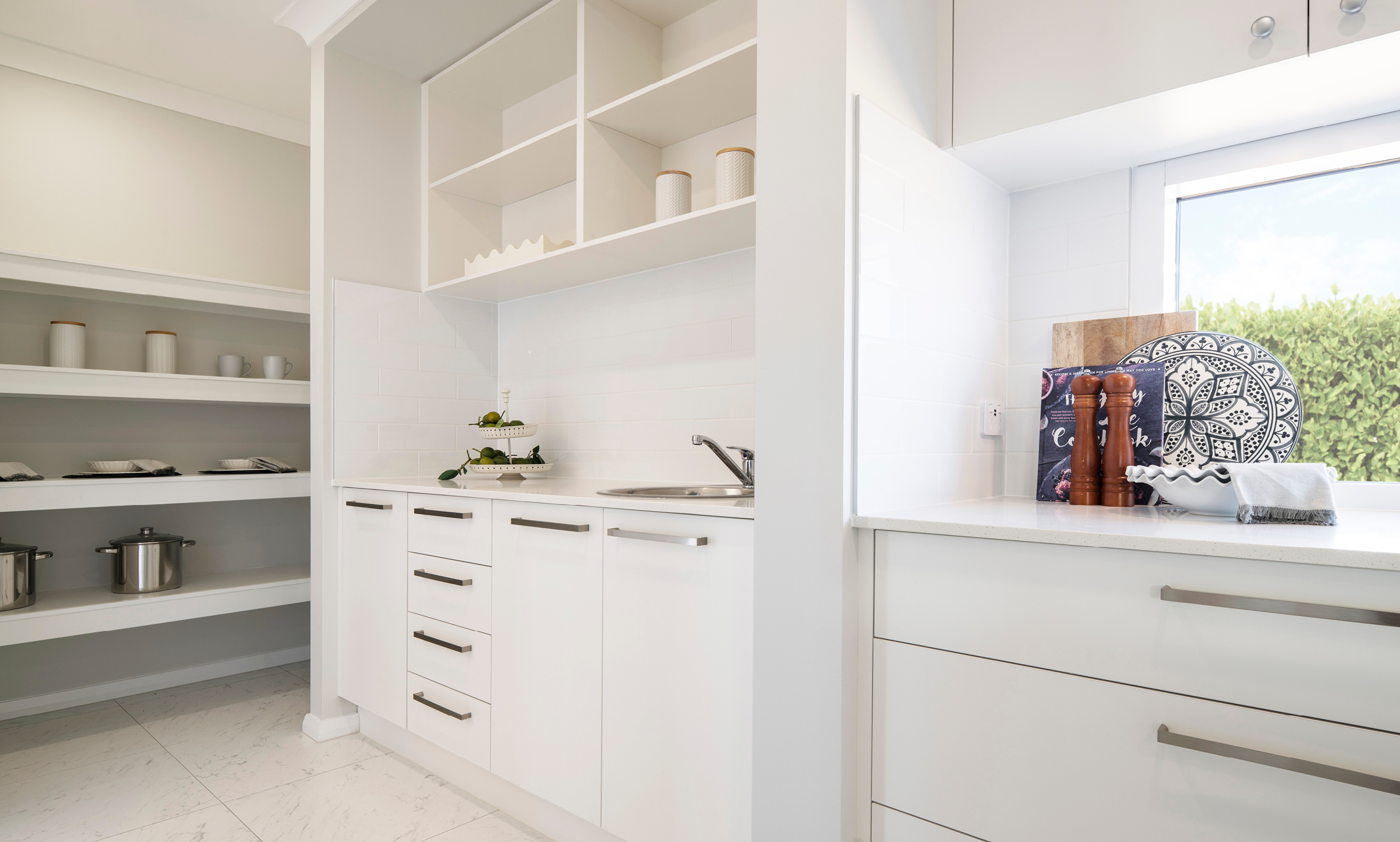 Kitchen with Butler's Pantry to the side. All white cabinetry with brushed nickel pull handles.